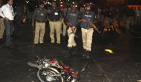 Police inspect the site of a blast that occurred during the cricket match between Pakistan and Zimbabwe, near Gaddafi Stadium in Lahore, Pakistan