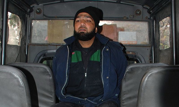 Malik Mumtaz Hussain Qadri, the bodyguard arrested in the shooting death of the Governor of Punjab Salman Taseer, is seen here detained in a police vehicle at the scene of the crime in Islamabad