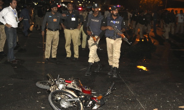 Police inspect the site of a blast that occurred during the cricket match between Pakistan and Zimbabwe, near Gaddafi Stadium in Lahore, Pakistan